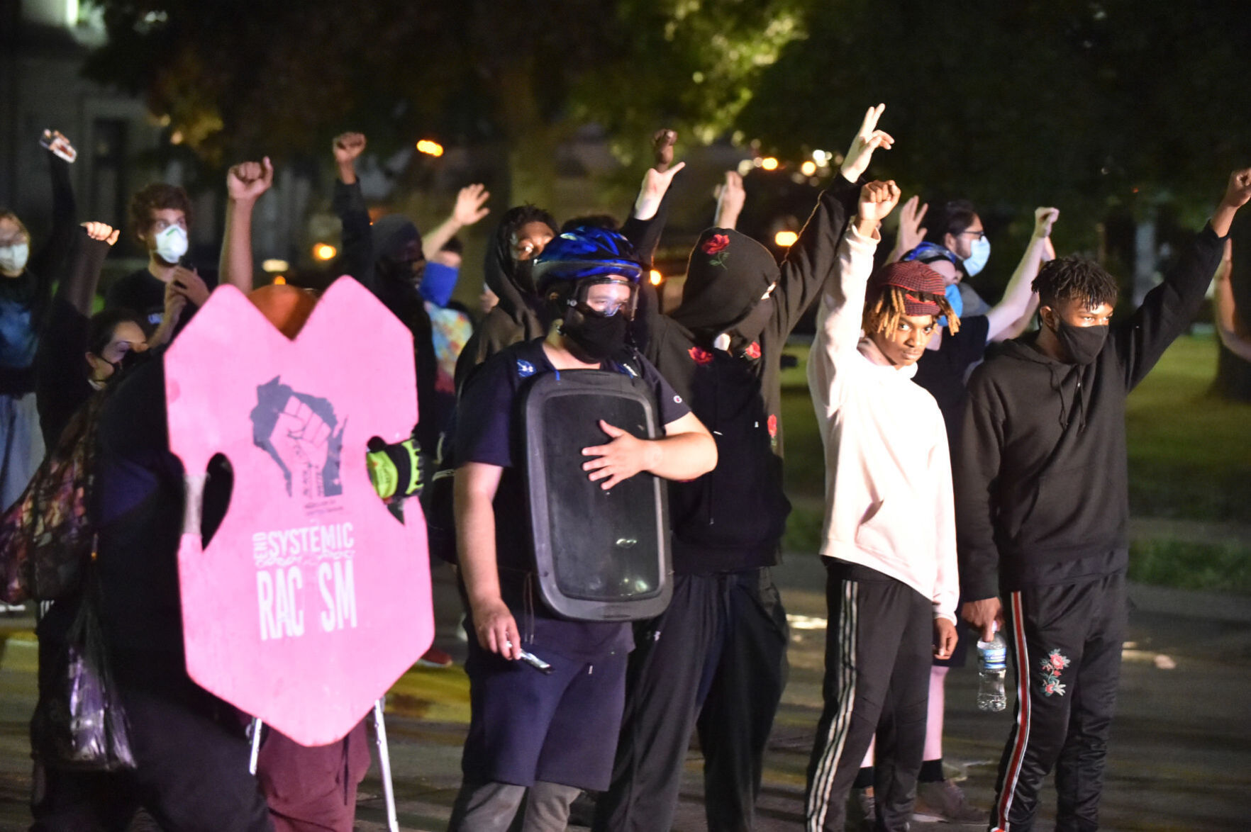 Protesters stand in defiance of police orders to clear Sheridan Road